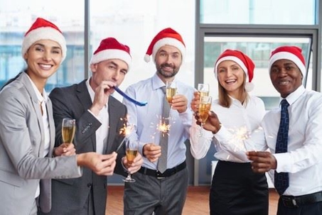 Office workers wearing santa hats