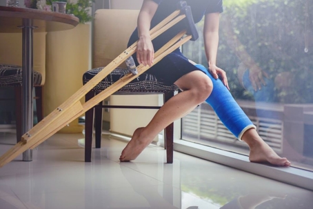 woman with a broken leg and crutches