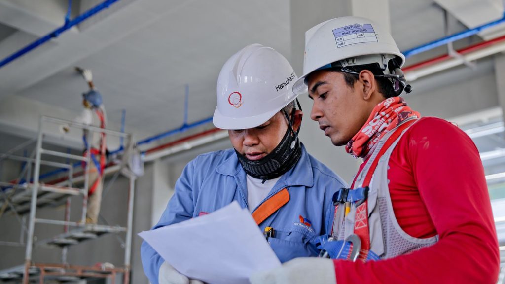 two workers reviewing injury paperwork