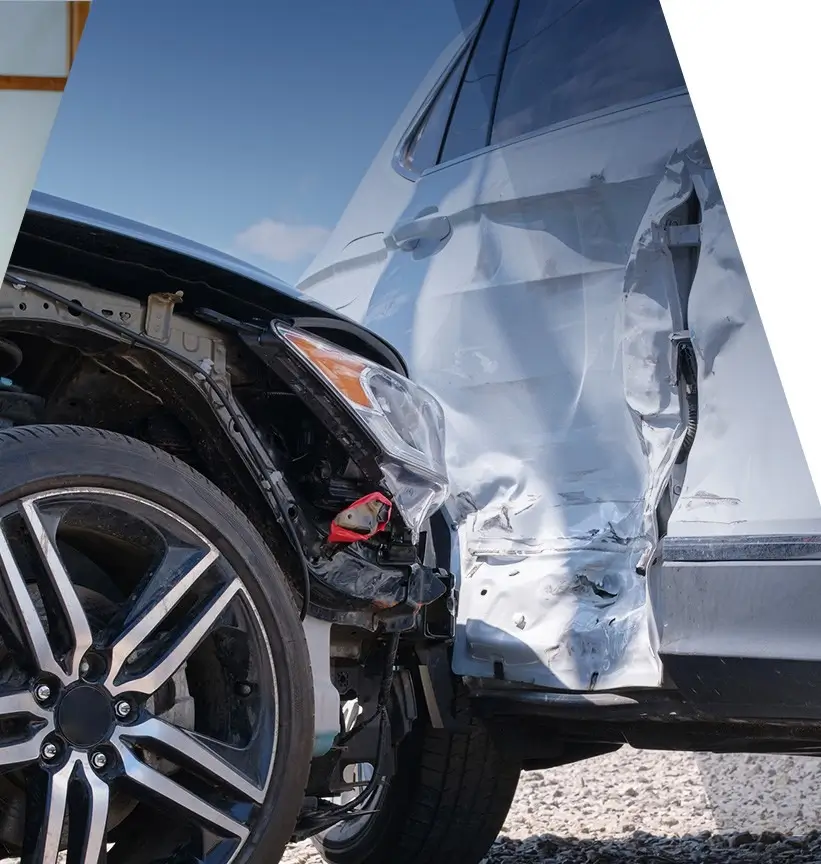 Two vehicles collided with visible front-end damage on one car and side impact damage on the other vehicle